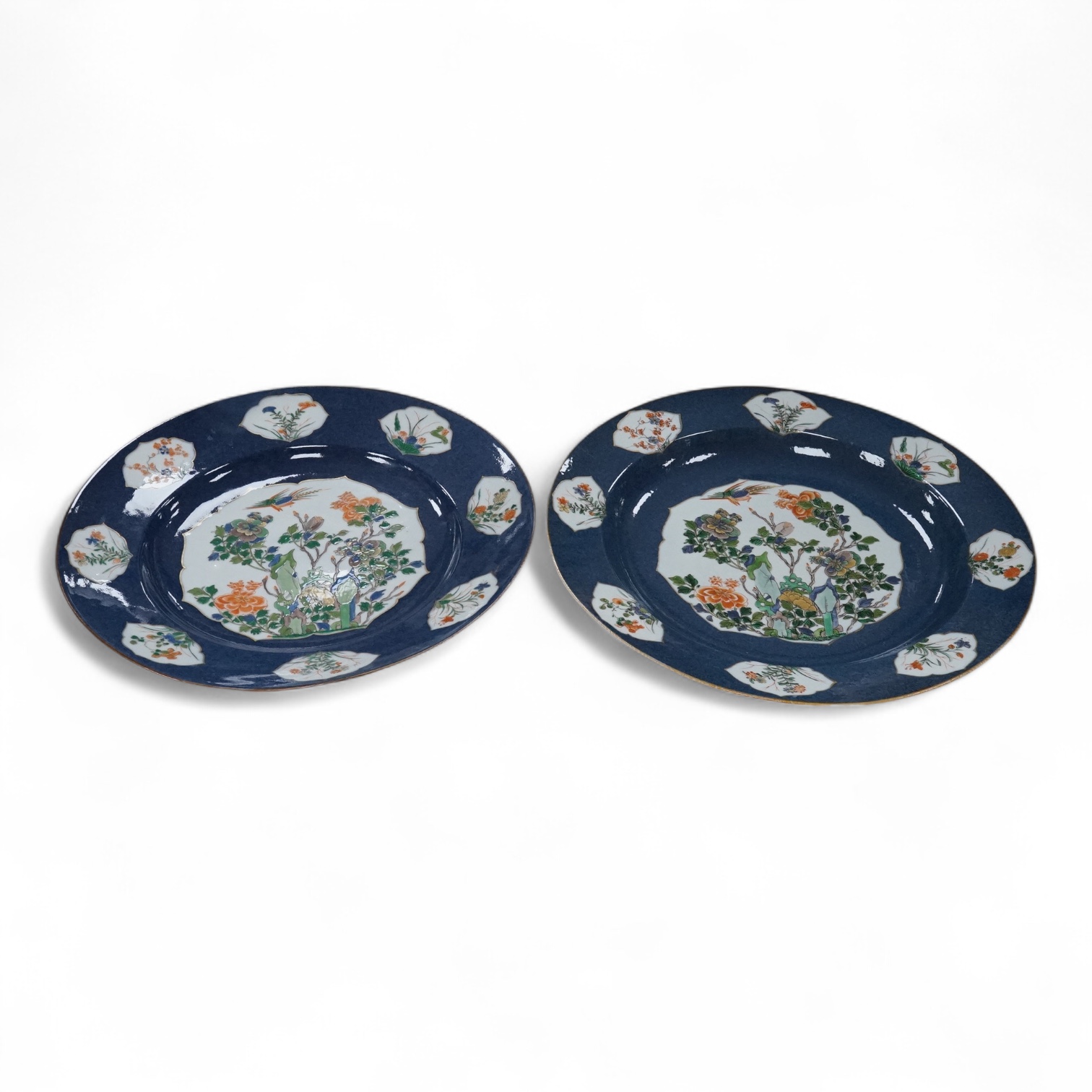 A near pair of Samson famille verte powder blue dishes in Chinese export style, each painted with a pheasant flying above blossoming branches and rocks, the border set with eight floral cartouches, underglaze blue ribbon